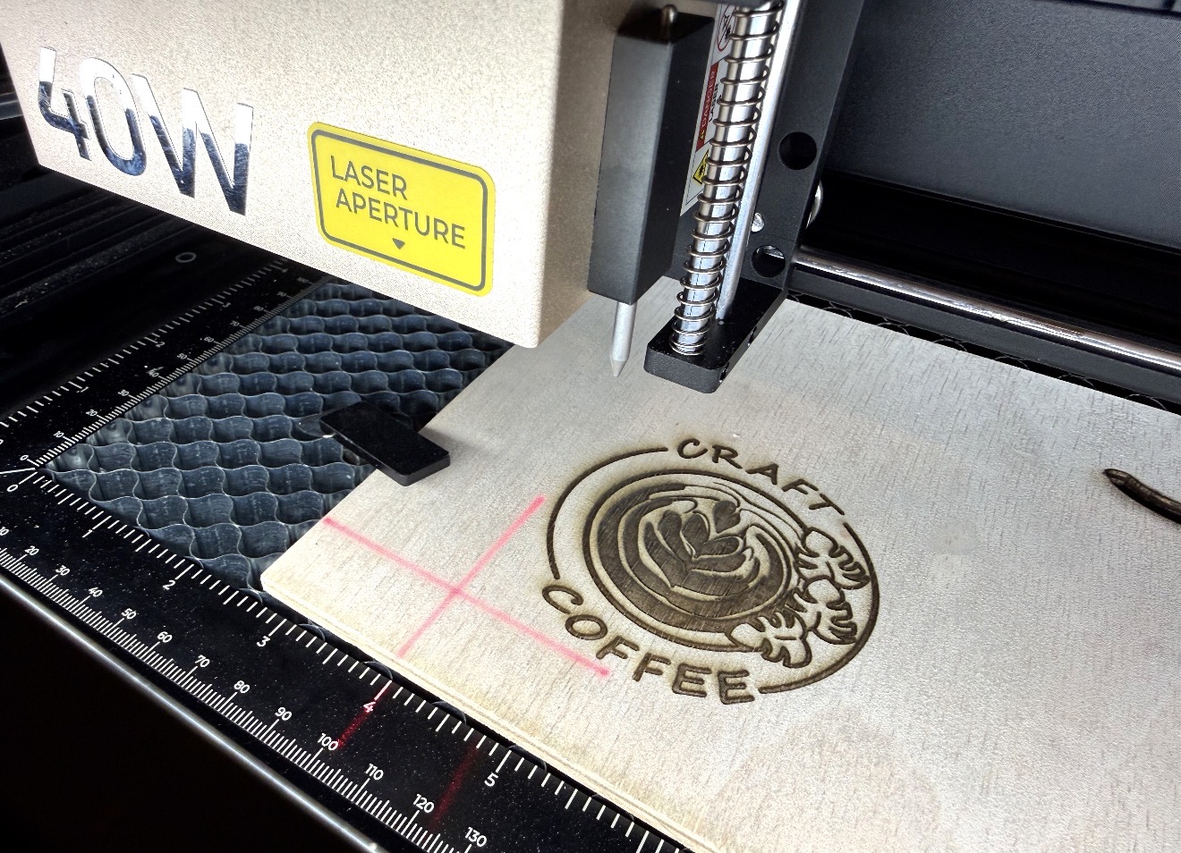 Laser engraving a Craft Coffee logo into a wood panel