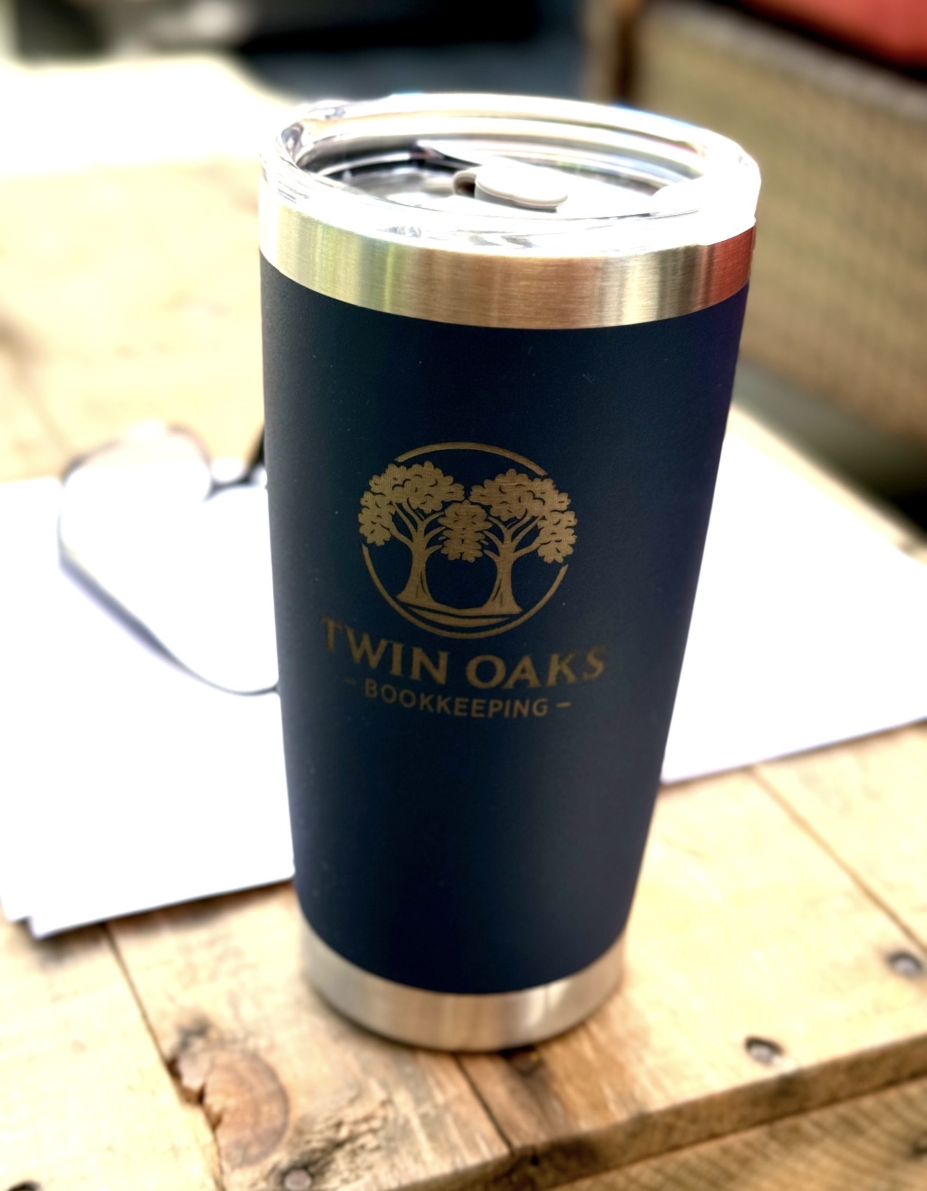 Navy tumbler engraved with the Twin Oaks Bookkeeping logo in gold